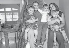  ?? Elizabeth Conley photos / Houston Chronicle ?? Shaun and Christie Conley of The Woodlands have three young children. The family was forced to turn to COBRA for health insurance and now pay $1,740 per month — more than their mortgage payment.