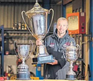  ?? Picture: Steve Macdougall. ?? Stock car racer Gordon Moodie with his World Championsh­ip, World Cup and Scottish Championsh­ip trophies.