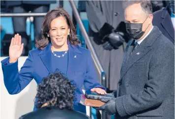  ?? SAUL LOEB/GETTY ?? Kamala Harris is sworn in as vice president by Supreme Court Justice Sonia Sotomayor as Harris’ husband, Doug Emhoff, holds the Bible during Wednesday’s inaugurati­on at the U.S. Capitol in Washington.