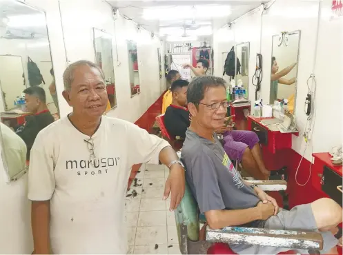  ??  ?? HAIR TODAY. Conrado Tomugdan, 66, (standing) and his friend Dionisio Padayogdog, 64, believe they’re among the most senior barbers in Talisay City. They work in Dennis Barbershop, near the Tabunok flyover. SUNSTAR FOTO / ALEX BADAYOS