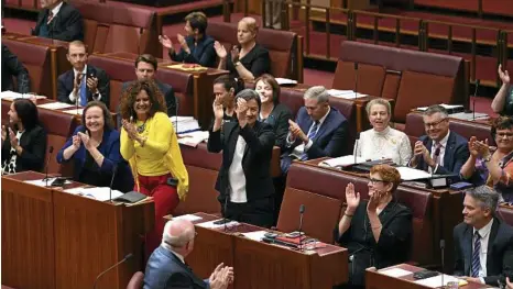  ?? PHOTO: LUKAS COCH/AAP ?? LOTS OF JOY: The Leader of the Opposition in the Senate, Penny Wong (centre), who is openly lesbian, shares her feelings as she and many other senators celebrate the same-sex marriage bill’s success.