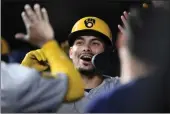  ?? NICK WASS — THE ASSOCIATED PRESS ?? The Brewers' Willy Adames is congratula­ted in the dugout after his three-run home run against the Orioles during the fifth inning of Friday's game in Baltimore.
