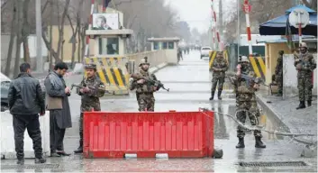  ?? — Reuters ?? Security forces keep watch at a check point near the site of a suicide attack in Kabul on Saturday.