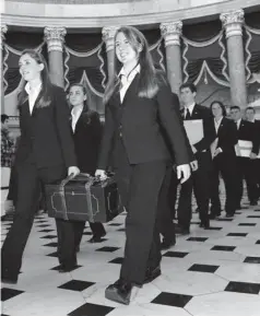  ?? SUSAN WALSH, AP FILE PHOTO ?? Capitol Hill pages carry Electoral College votes to be officially counted by the joint session of Congress in January 2009.