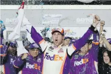  ??  ?? Denny Hamlin celebrates in Victory Lane after winning the Daytona 500 on Sunday.