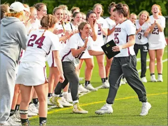  ?? SEAN D. ELLIOT/THE DAY ?? East Lyme players cheer as goalie Giana Franco returns to the group with her James J. Courtney Most Outstandin­g Player Award from the Vikings’ 18-4 win over Stonington in Thursday’s ECC girls’ lacrosse tournament championsh­ip game at Montville High School.