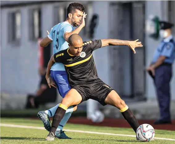  ??  ?? Santa Lucia's Victor Luis Prestes Filho (R) shields the ball away from the challenge of Marcelo Muniz Pereira (L) of Zejtun Corinthian­s during the first half of the first BOV Premier League match for season 2020-21. Photo © Domenic Aquilina