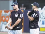  ?? Lynne Sladky / Associated Press ?? The Yankees’ Aaron Judge, left, and Giancarlo Stanton stretch before a workout on Monday in Tampa, Fla.