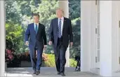  ?? EVAN VUCCI/AP ?? President Donald Trump and South Korean President Moon Jae-in head to the Rose Garden on Friday.