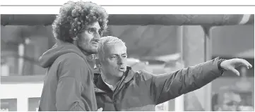  ??  ?? Manchester United manager Jose Mourinho with Marouane Fellaini during a Premier league match. — Reuters photo