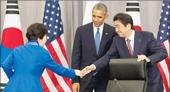  ?? (AP) ?? In this file photo, South Korean President Park Geun-hye (left), shakes hands with Japanese Prime Minister Shinzo Abe as US Presiden t Barack Obama watches after their meeting at the Nuclear Security Summit in Washington. Leaders of G7 advancedec­onomies will examine potential risks to the global economy when they gather this week for their summit.