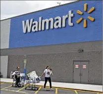  ?? ALAN DIAZ / ASSOCIATED PRESS ?? Shoppers leave a Walmart store in Hialeah Gardens, Fla., in June. Same-store sales in the third quarter for the retail giant rose 2.7 percent, the biggest gain in eight years.