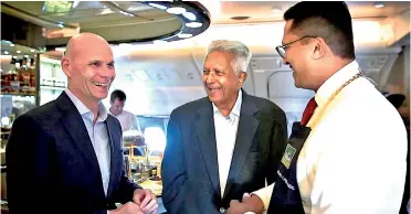  ??  ?? Emirates Vice President Catering, Global Food and Beverage Darren Bott (left), Merrill J. Fernando (centre) and his son Dilmah Tea CEO Dilhan Fernando during the tea master class aboard an Emirates A380