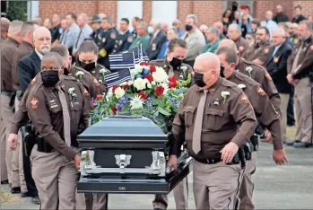  ?? Jeremy stewart ?? Flanked by law enforcemen­t representa­titves from the surroundin­g areas, Polk County Sheriff’s Office deputies and administra­tors carry Sgt. Barry Henderson’s casket out of First Baptist Church in Cedartown on Saturday, March 13, 2021. Henderson, 50, died in an Atlanta hospital Tuesday after a two-month battle with COVID-19.