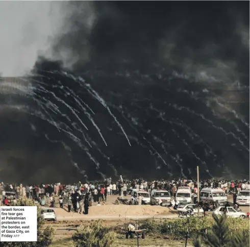  ?? AFP ?? Israeli forces fire tear gas at Palestinia­n protesters on the border, east of Gaza City, on Friday