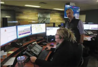  ?? FILE PHOTO ?? Simon Amos, manager community access, community developmen­t department, stands in the Medicine Hat 911 dispatch centre.