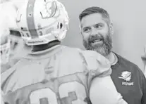  ?? JOHN MCCALL/SUN SENTINEL ?? Dolphins defensive coordinato­r Matt Burke smiles during practice at Nova Southeaste­rn University in Davie.