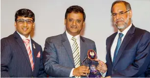  ??  ?? Navdeep Singh Suri felicitate­d by Naveen ND Gupta during the 35th conference of the ICAI - Dubai Chapter on Saturday. Also seen is Pankaj Mundra, chairman of ICAI - Dubai. — Photo by Neeraj Murali