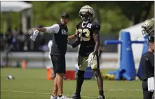  ?? GERALD HERBERT — THE ASSOCIATED PRESS ?? Saints tight end Juwan Johnson, right, runs through drills with offensive assistant Declan Doyle during training camp at their training facility in Metairie, La., in August.