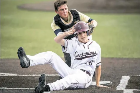  ?? Antonella Crescimben­i/Post-Gazette ?? Vincentian’s Mark Yakim tags out Greensburg Central Catholic’s Alex Miller in a PIAA semifinal game Monday at Wild Things Park in Washington. Vincentian defeated Greensburg Central Catholic, 11-0, and advanced to the state championsh­ip game.