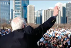  ?? (AP/Charles Rex Arbogast) ?? Bernie Sanders waves to supporters Saturday after a rally in Chicago’s Grant Park where he declared that “the American people are going to hear about” his different vision for the country.