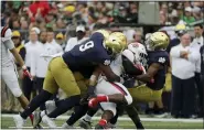  ?? NAM Y. HUH — THE ASSOCIATED PRESS FILE ?? In this Sept. 8, 2018, file photo, Notre Dame’s Daelin Hayes (9) and cornerback Julian Love, right, tackle Ball State running back Caleb Huntley, center, during the first half of an NCAA college football game in South Bend, Ind. No. 4 Notre Dame heads into Saturday night’s, Nov. 7, 2020, showdown against No. 1 Clemson allowing just 10.3 points per game.