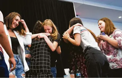  ?? Marie D. De Jesus / Houston Chronicle ?? March for Our Lives Houston activist Paige Cromley, center left, embraces Santa Fe High School student Bree Butler at the end of a news conference Friday, when Santa Fe students spoke a week after a shooting killed 10 people at their high school.