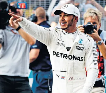  ??  ?? Making a point: Britain’s Lewis Hamilton celebrates securing pole position after final qualifying for today’s Malaysian Grand Prix