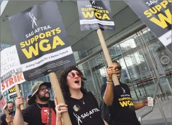  ?? Michael M. Santiago Getty Images ?? GUILD MEMBERS picket outside Disney’s upfront presentati­on to advertiser­s in New York on May 16. The WGA says its members have also protested to block filming of the Disney+ series “Daredevil: Born Again.”