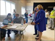  ??  ?? The DeWines watch as Barry Gertner, 54, gets a COVID-19 vaccine Saturday at a clinic in Piqua. Miami County Health Commission­er Dennis R. Propes said about 300 people were vaccinated at the clinic on Saturday.