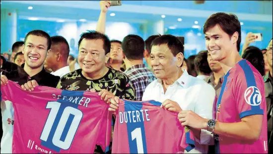  ??  ?? President Duterte and birthday celebrant Speaker Pantaleon Alvarez receive honorary jerseys from Davao Aguilas football player Phil Younghusba­nd during a birthday celebratio­n at the New Tagum City Hall in Davao del Norte the other night.