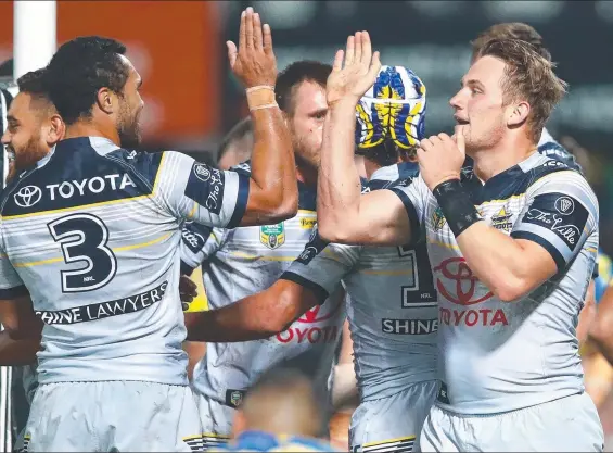  ??  ?? HIGH FIVES: Coen Hess of the North Queensland Cowboys ( right) celebrates his try against the Parramatta Eels in Darwin with teammate Justin O’Neill.