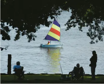  ?? DON CAMPBELL/THE HERALD-PALLADIUM ?? With summer here, many COVID-19 infections are reported, but few deaths. Above, a sailboat last month on the St. Joseph River in Michigan.