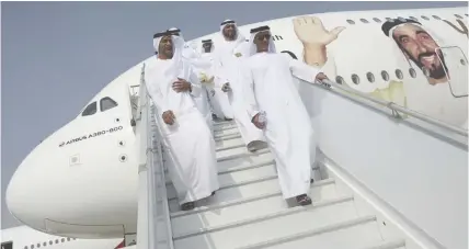  ??  ?? Emirati officials visit an Airbus A-380 decorated with an image of the late Sheikh Zayed bin Sultan Al Nahyan, during the opening day of the Dubai Air Show, United Arab Emirates.
