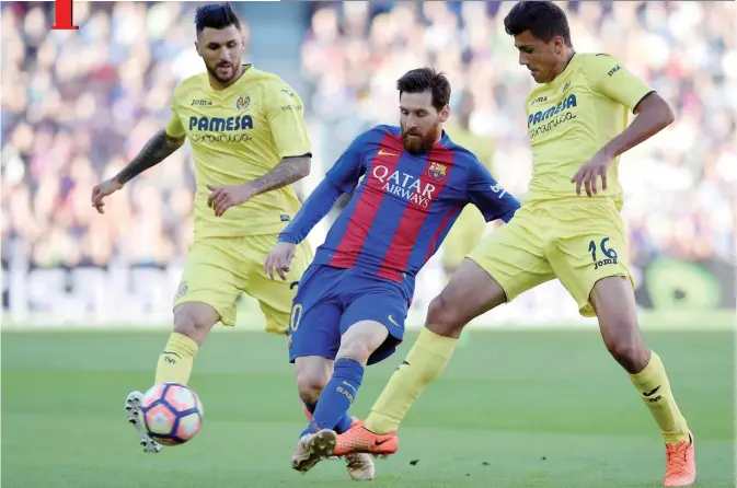  ??  ?? BARCELONA: Barcelona’s Argentinea­n forward Lionel Messi (C) vies with Villarreal’s midfielder Rodrigo Hernandez (R) and Villarreal’s Italian midfielder Roberto Soriano during the Spanish league football match FC Barcelona vs Villarreal CF at the Camp...