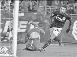  ?? Steven Senne Associated Press ?? LEE NGUYEN, right, scores on Columbus goalkeeper Steve Clark in an MLS playoff game in 2014. LAFC has acquired the rights to the veteran midfielder.