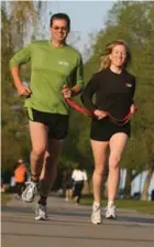  ?? TORONTO STAR FILE PHOTO ?? Brian Mclean, who is legally blind, runs tethered to his guide, his wife Trisha.