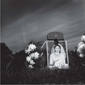  ??  ?? Mangwol-dong cemetery, Gwangju, South Korea, 1991; photograph by Sangil Yi from his ‘Mangwol-dong’ series. It appears in Suejin Shin’s book Contempora­ry Korean Photograph­y, published recently by Hatje Cantz.