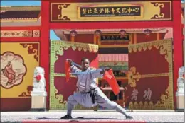  ?? PENG LIJUN / XINHUA ?? A competitor displays his kung fu skills during the first African Shaolin Kung Fu Games held at the Shaolin Cultural Center in Lusaka, Zambia, on June 25. About 150 contestant­s from 22 African countries participat­ed in the kung fu event and other activities that were aimed at promoting kung fu on the continent and enhancing cultural exchanges.