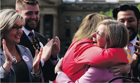  ?? DAVID BLOOM ?? Premier Rachel Notley, right, hugs Energy Minister Margaret McCuaig-Boyd during a press conference where Notley announced that the federal government, with support from the Alberta government, has purchased the Trans Mountain Pipeline and associated...