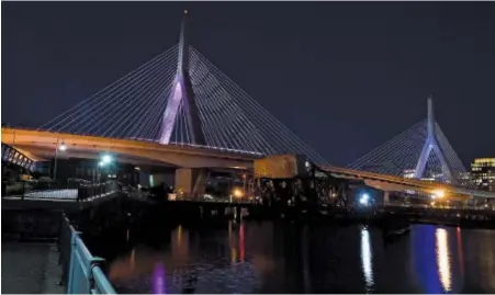  ?? HERALD PHOTO BY JIM MICHAUD ?? PAINFUL REMEMBRANC­E: Pink and blue lights shine on Boston’s Zakim bridge last night on the eve of today’s National Pregnancy and Infant Loss Remembranc­e Day.
