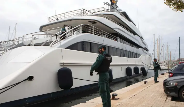  ?? Photo: AP ?? FILE - Civil Guards stand by the yacht called Tango in Palma de Mallorca, Spain, Monday April 4, 2022. U.S. federal agents and Spain's Civil Guard are searching the yacht owned by a Russian oligarch. The United States and allies are again escalating sanctions against Russia, Wednesday, April 6, after evidence that Russian troops murdered Ukrainian civilians in a town near Kyiv.