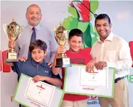  ??  ?? School Team Event winners Kvahn Tejwani and Reshan Algama (center left and center right) from Colombo Internatio­nal School receiving their award from Air Chief Marshal Harsha Abeywickra­ma, the President of the Sri Lanka Golf Union (far left) and Prabodha Samaraseke­ra, the CEO of NDB Wealth Management (far right)