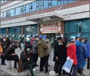  ?? (AP) ?? People line up outside a clinic Friday at Wuhan Union Hospital in Wuhan, China, the starting point for the corornavir­us.