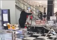  ?? Contribute­d screenshot ?? Video footage captured by a witness shows a man knocking over display cases and racks Monday night in Bloomingda­le’s at The SoNo Collection.