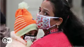  ??  ?? A woman and her child wearing face masks in Jammu