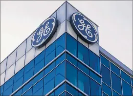  ?? JOHN MINCHILLO / AP ?? A probe of General Electric compounds the mess the firm is sorting through after a year of management turmoil, cash-flow concerns and falling demand in key businesses. GE was the biggest Dow Jones industrial average loser last year, falling 45 percent.