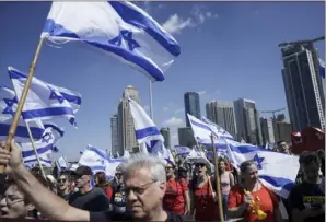  ?? Oded Balilty/Associated Press ?? Israelis protest against plans by Prime Minister Benjamin Netanyahu’s new government to overhaul the judicial system on Thursday in Tel Aviv.