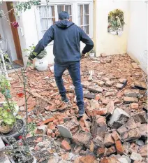  ?? REUTERS ?? A man walks over debris after an earthquake, in Zagreb, Croatia on Tuesday.