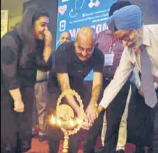  ?? HT PHOTO ?? Dr GS Wander (R), head, Hero Heart Centre, DMCH, Ludhiana, and Dr Vitull K Gupta, organising secretary, lighting a lamp at the physicians’ conference in Bathinda on Sunday.